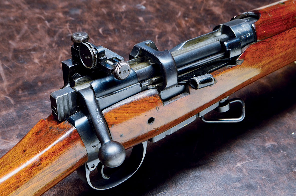 The No. Mk. III has a magazine cutoff that allows single shots while holding the 10-round magazine in reserve. Coincidentally, one can use the rifle as a single shot without the magazine in place. These photos show the cutoff open and closed.